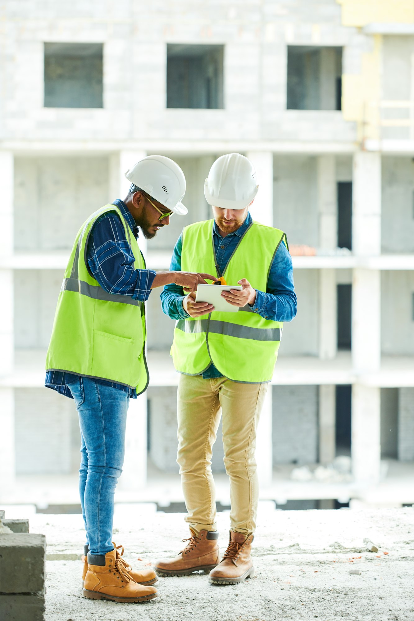 Busy coworkers discussing plan of construction work